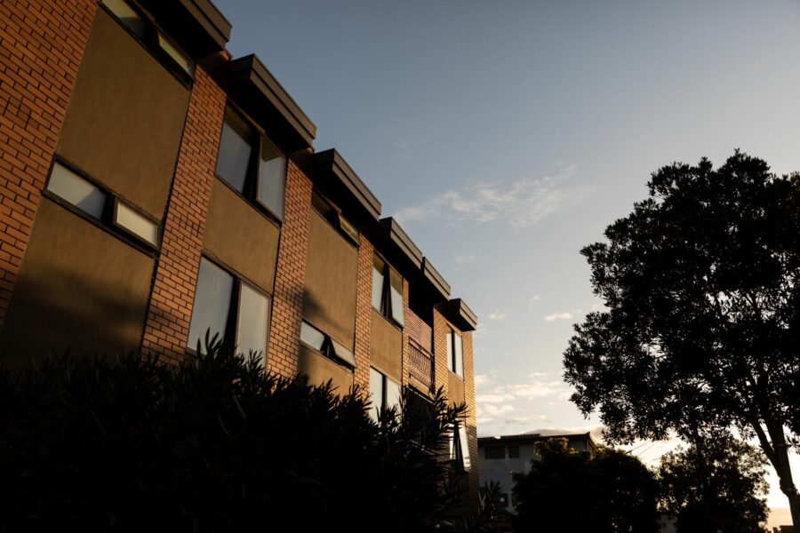 A block of brown-brick social housing flats.