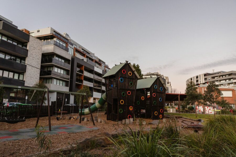A inner city playground surrounded by apartments