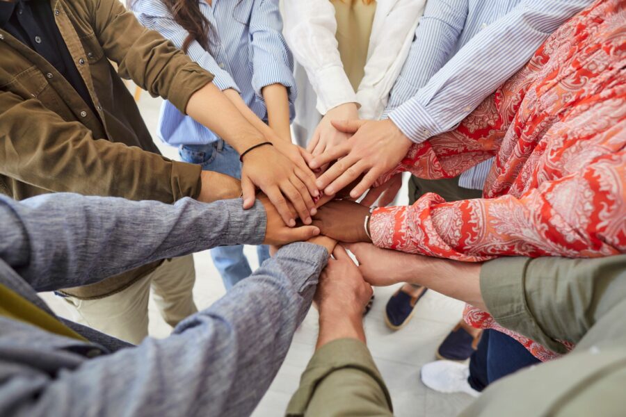 A diverse group of people stacking their hands.