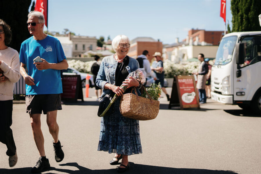 Woman walking through Launceston farmers market