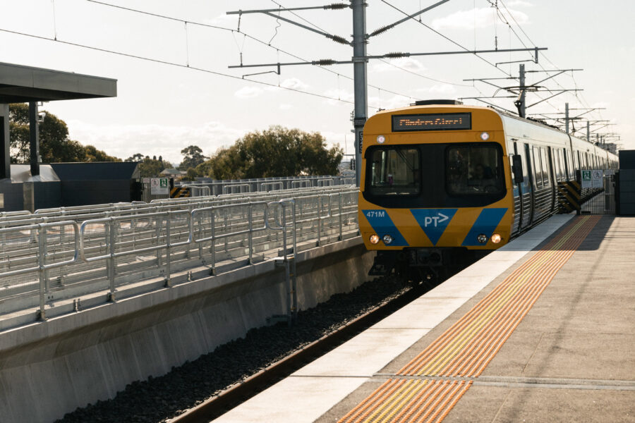 A train destined for Flinders Street arrives at a station