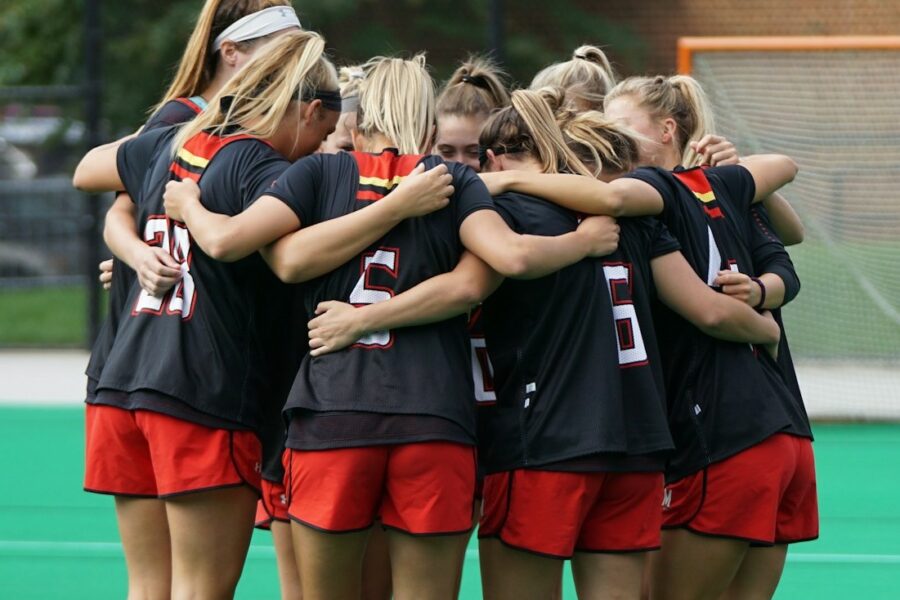 Women's sports team standing in a huddle