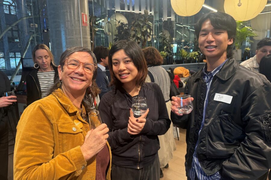 Capire Senior Associate Denise Francisco networking with two attendees at Capire's recent event on inclusive and accessible engagement. They are all holding a drink and smiling.